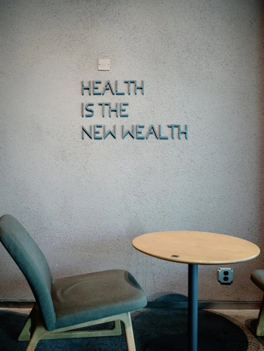 A wall in a quiet office reading Health is the new wealth